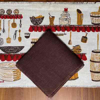 Woodenware placemat with solid color square linen napkin.
