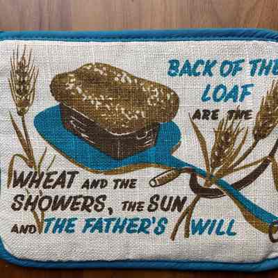 Matching Daily Bread 12 potholder in blue on white linen.: Collection of Sara Leeper.