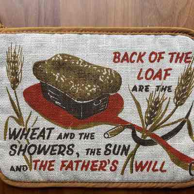 Matching Daily Bread 11 potholder in red on natural linen.: Collection of Sara Leeper.