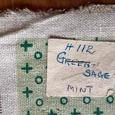 Handwritten tag with product number (112) and color names noted.