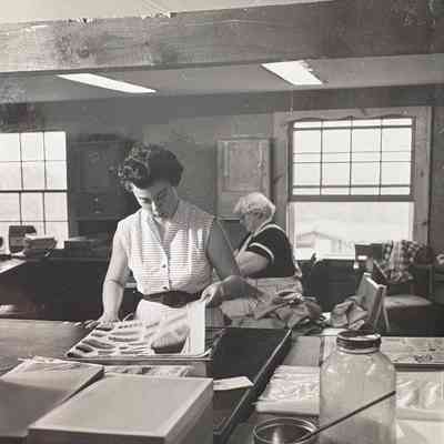 Daily Bread 453 tablecloth being packaged in the Country Prints workshop, c.1958-60.: Collection of Sara Leeper. Image: unidentified photographer.