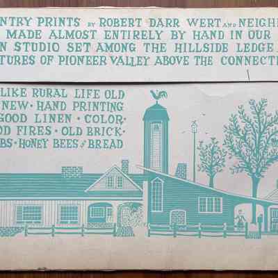 Back of table linen packaging with Country Prints story and elevation view of the barn workshop.