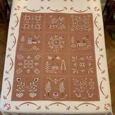 Finished cross stitch quilt kit by the Bucilla Needlework company, American Provincial 2868; see “Kits”.: Cross stitch in brown, black and white floss on brown and white cotton fabric. PKM collection. Image: PKM