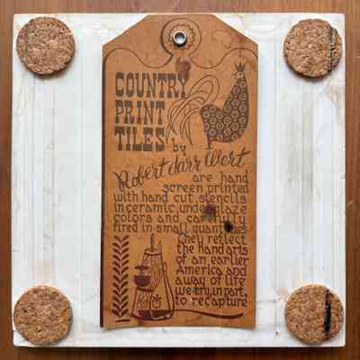 Tile back with cork pads and Country Prints/Ceramo label hanger.