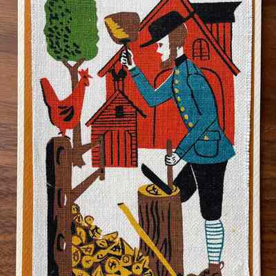 Chopping Wood: A man in a barnyard is in the act of splitting a log, a pile of split wood at his feet. (Six colors)