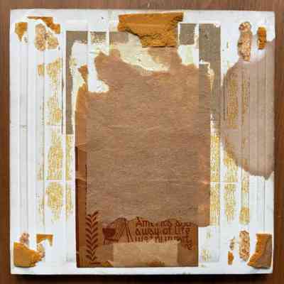Tile back, with cork pads removed and partial Country Print Tiles label hanger.