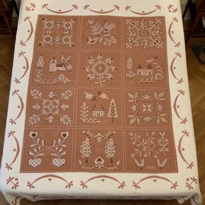Finished Bucilla American Provincial No.2868 cross stitch quilt kit.: Brown and white cotton ground fabrics, with black and white stitching on brown fabric panels, and red stitching on white border. PKM collection. Images: PKM, unless noted.