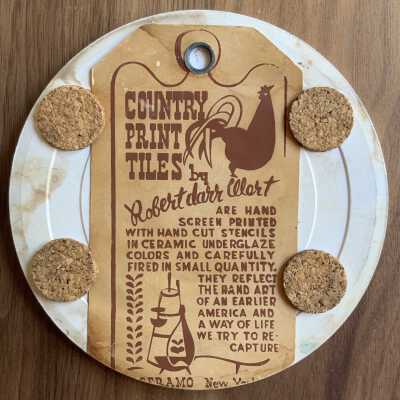Tile back with Country Print Tiles label hanger and cork pads.
