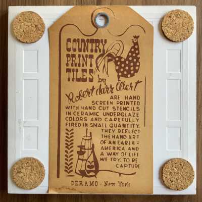Tile back with Country Print Tiles label hanger and cork pads.