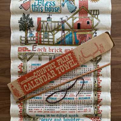 Box with contents: House Blessing 513 calendar towel.