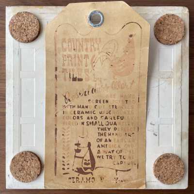 Tile back with Country Print Tiles label-hanger.