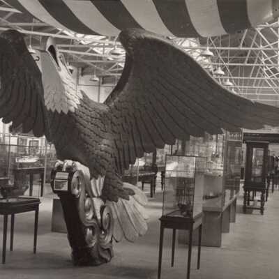 USS Lancaster figurehead, c.1880, prior to restoration.: The large eagle at the base of the composition is modeled on the USS Lancaster figurehead. Placement and position of white feathers is consistent with this image. Image: The Mariners’ Museum.