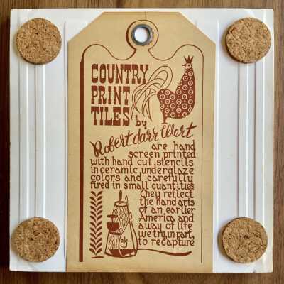 Tile back with Country Print Tiles label hanger and cork pads.