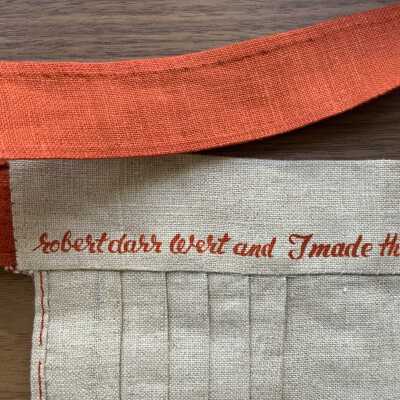 Back of apron waist.: Possible branding of ‘cut and sew’ kits.