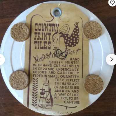 Back of tile with Country Print Tiles label hanger and cork pads.