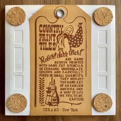 Tile back with Country Print Tiles label hanger and cork pads.