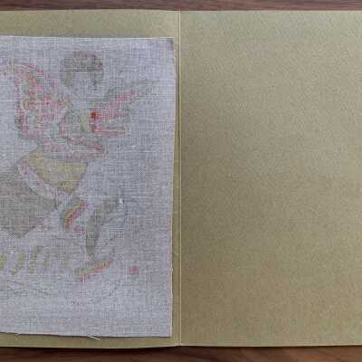 Card open.: Textile hangs freely from glue strip at top edge.