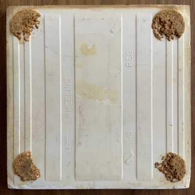 Tile back with Country Print Tiles label-hanger removed and partial cork pads.