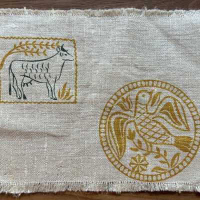 Cocktail Napkin C: Top: rectangular mold depicting a cow with horns. Bottom: circular mold depicting a bird and plants PKM collection.