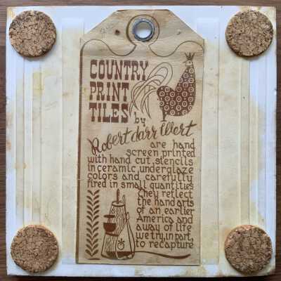 Tile back with Country Print Tiles label hanger and cork pads.