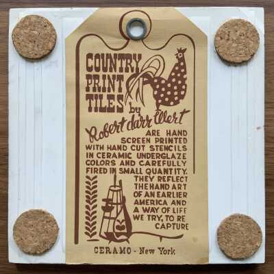 Tile back with Country Print Tiles label hanger and cork pads.