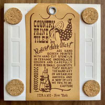 Tile back with Country Print Tiles label hanger and cork pads.