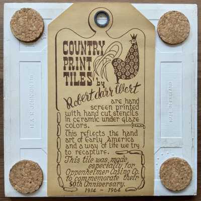 Custom Country Print Tiles label hanger.: Design incorporates sausage links, a sausage making tool and a description of why the tile was commissioned.