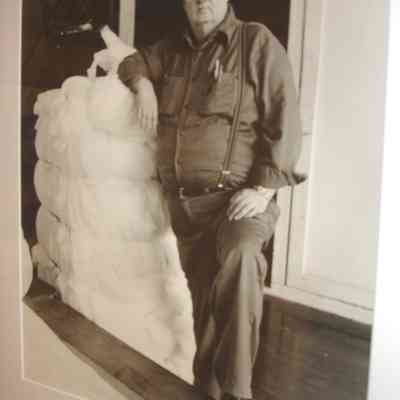 Needle Room foreman Russell Collins leaning on bat stock in the Knox Mill