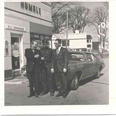 3 men standing outside Camden Esso Station