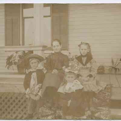 Four children on a porch