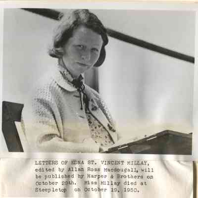Edna St. Vincent Millay outdoors at writing table.