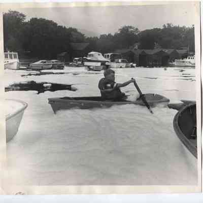 Boy rowing through foam in Camden Harbor