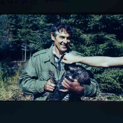 Man holds hen turkey