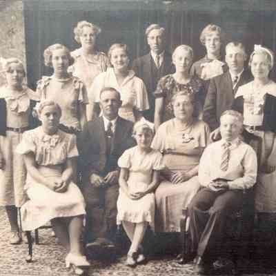 Photo courtesy Ancestry.com Ackerman/Kneip/Fleischer/Hagen Family Tree by Jackie Ausk: John Peter Jr. and Maggie (Beitz) Kneip family photo, about 1932. Front, l-r: Mary, father John Peter, Rose, mother Maggie & John Adam; Middle, l-r: Monica, Ilene, Gertrude, Margaret, Leonard & Veronica; back, l-r: Agnes Mary, Joseph Peter, & Cecilia Anna.