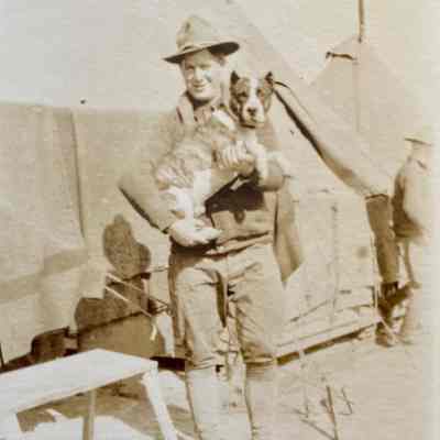 Soldier holding a Dog: a photo from Nelmer Talmo, bicycle repair shop operator in Hillsboro in the early 1900s