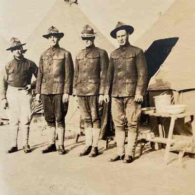 Four Soldiers by Tents: a photo from Nelmer Talmo, bicycle repair shop operator in Hillsboro in the early 1900s