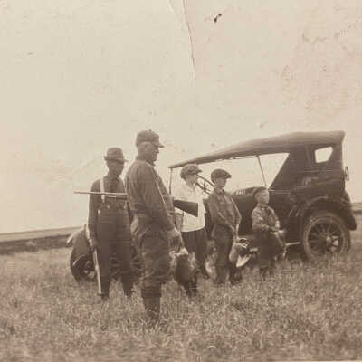 Hunting party holding birds