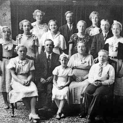Photo courtesy Ancestry.com Ackerman/Kneip/Fleischer/Hagen Family Tree by Jackie Ausk: JP Jr. and Maggie Kneip family photo, about 1932. Front, l-r: Mary, JP, Rose, Maggie & John Adam; Middle, l-r: Monica, Ilene, Gertrude, Margaret, Leonard & Veronica; back, l-r: Agnes Mary, Joseph Peter, & Cecilia Anna.
