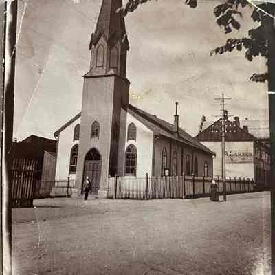 Photo of high steepled church of unknown location