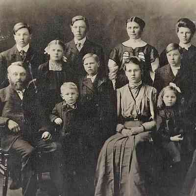Albert Amb with parents and siblings; Photo courtesy granddaughter Jane (Zahnow) Cox: Albert Amb by father at front left in a 1907 Carl and Olina Amb family photo: Front(l-r): Carl, Albert, Milla, Emma, Joseph (Joe) & Olina; Back(l-r): John, Louise, Conrad, Theodore (Ted), Clara, Michael (Mike), Sophia & Randina.