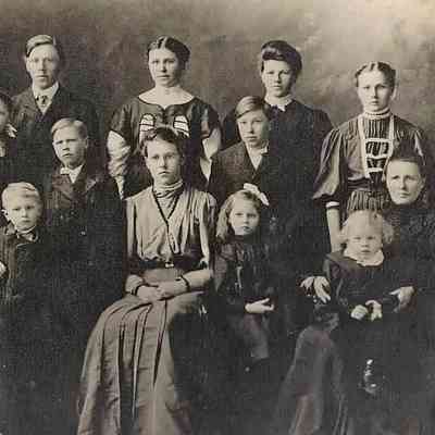 Joseph Amb with parents and siblings; Photo courtesy granddaughter Jane (Zahnow) Cox: Joseph Amb on mother's lap at front right in a 1907 Carl and Olina Amb family photo: Front(l-r): Carl, Albert, Milla, Emma, Joseph (Joe) & Olina; Back(l-r): John, Louise, Conrad, Theodore (Ted), Clara, Michael (Mike), Sophia & Randina.