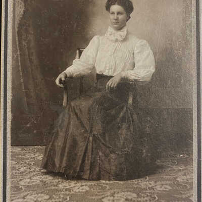 Women sitting in chair, Sheyenne, ND, studio