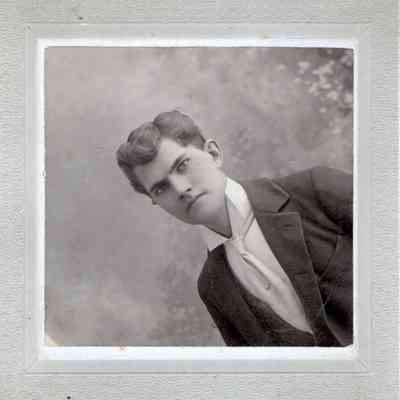 Photograph of young man, paired with "Man's hat on person" photograph: Photograph taken at C. E. Fuller Studio in Northwood, ND