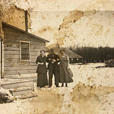 Postcard - Unknown three people by house