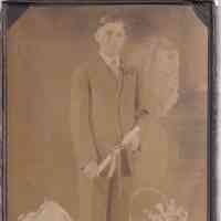 Formal Portrait of Young Man Holding Diploma with Floral Studio Props