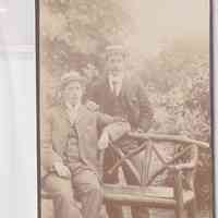 Two Gentlemen in Straw Boater Hats at Rustic Bench