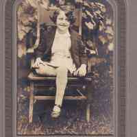 Portrait of Young Girl Seated Outdoors in Wooden Chair