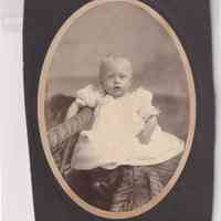 Infant Seated on Wicker Chair — Oval Studio Portrait
