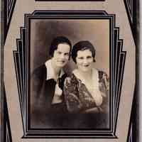 Studio portrait of two young women posed together, presented in a bold Art Deco mount.