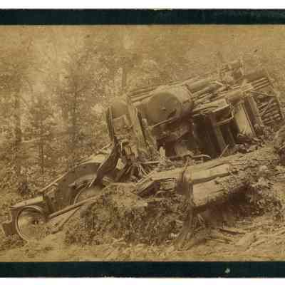 2022.057.054: Black and white photograph of a wrecked engine on the side of Lookout Mountain.